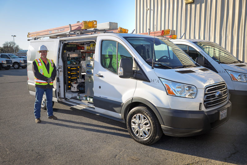 worker standing next to van