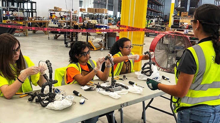Campers learn how to wire lamps at Rosendin facility