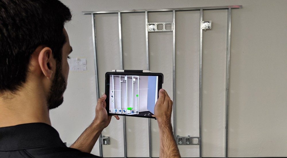 A Rosendin employee uses augmented reality (Building Forward)