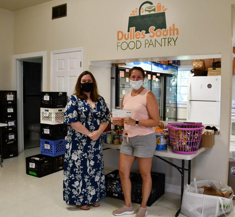 worker donating to food pantry